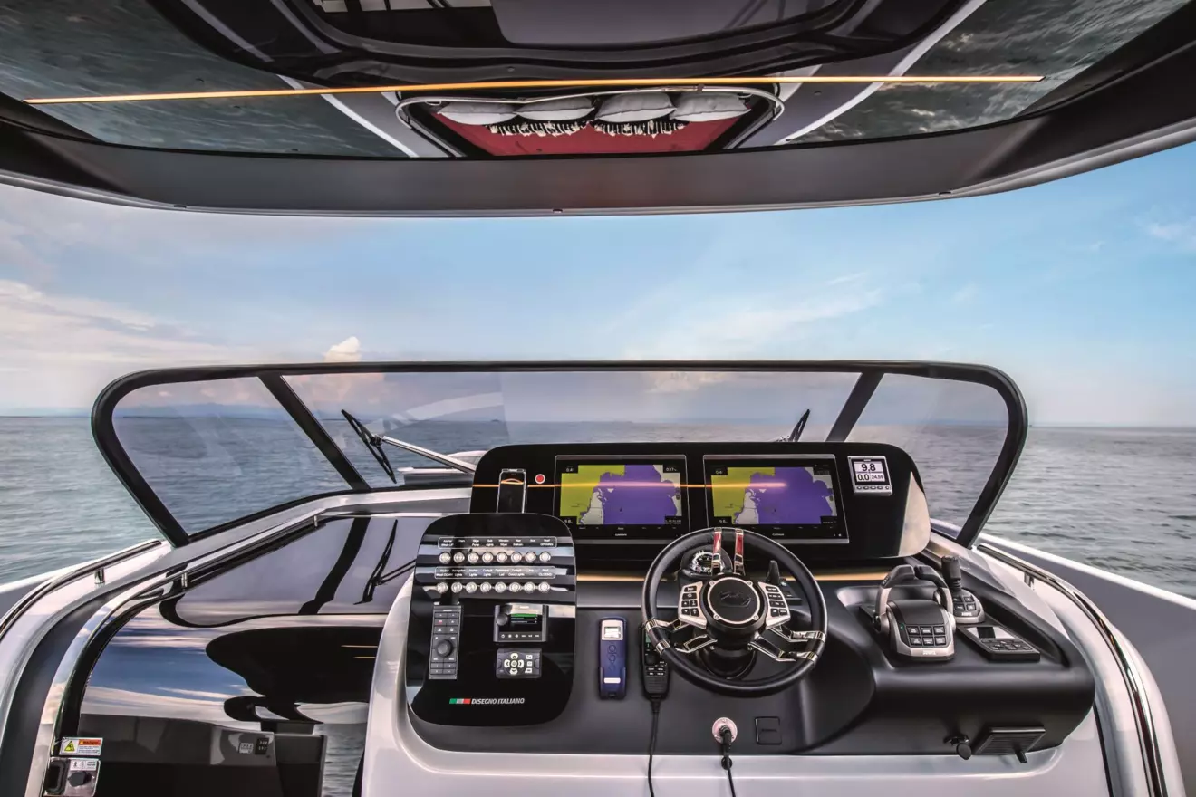 The modern helm station of the Cranchi A46 featuring twin Volvo Penta displays and a sporty leather steering wheel