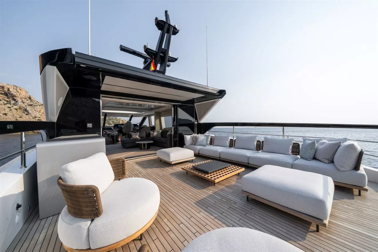 The open aft deck terrace of the Sunseeker Ocean 82 Enclosed flybridge arranged with an outdoor lounge