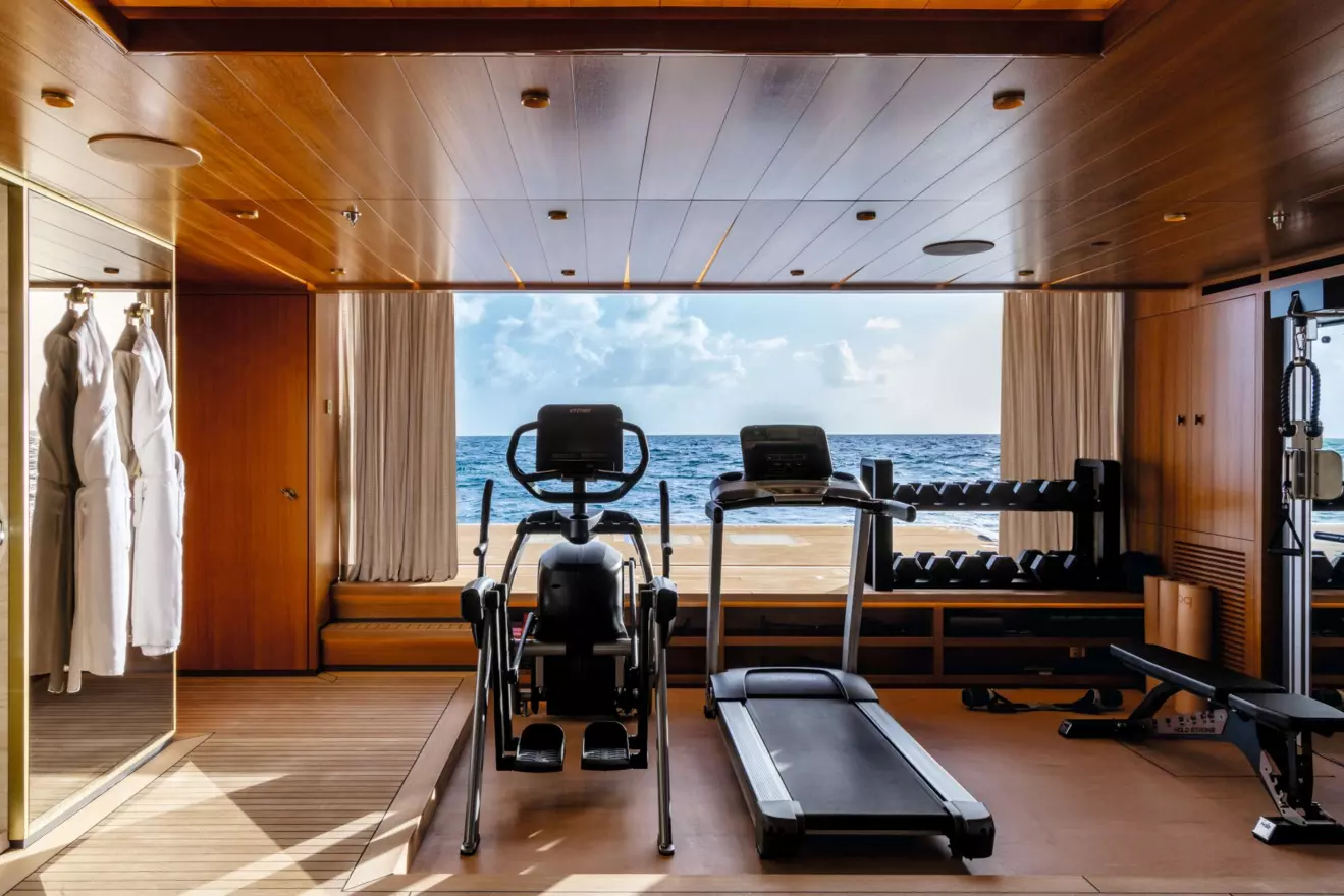Fitness area and wellness spa on the lower deck of M/Y Amor &agrave; Vida, featuring high-end gym equipment with views over the sea