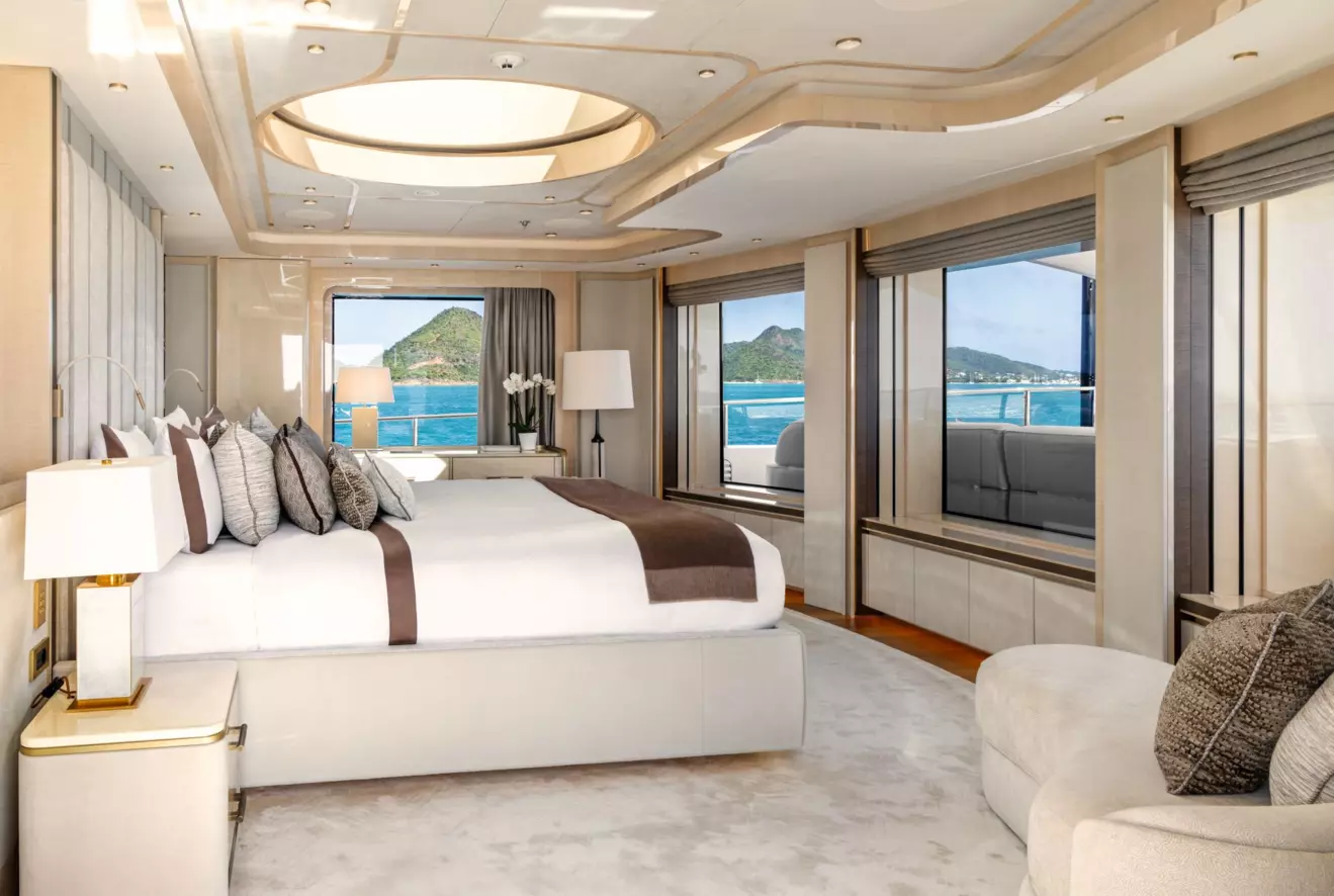 Panoramic owner's suite on the upper deck of M/Y Amor &agrave; Vida with 180-degree views and a stargazing skylight above the bed