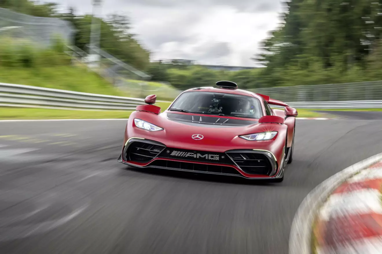 High speed shot of the Mercedes AMG ONE cornering on a circuit, emphasizing its performance and aggressive racing lines.